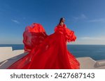Woman Red Dress, Fashion Model In Long Silk Waving Gown Wings, Flying Fabric in Santorini, Blue dom.