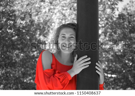 Similar – Young blonde woman portrait laughing outdoors sitting in a garden, and looking at camera.