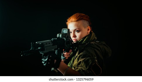 Woman with red hair and with a bandage on his face, hold machinegun in military uniform.