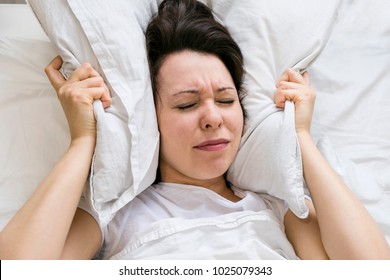 Woman With Red Hair In Her Bed With Insomnia And Can't Sleep On A White Background