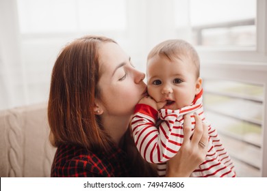 Woman With Red Hair Kisses Pretty Little Boy