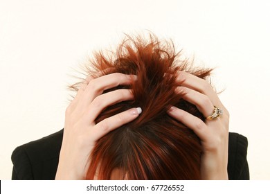 Woman With Red Hair And Manicured Hands In Hair Stressed Or With Headache.