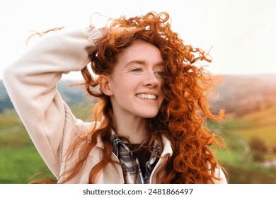 Woman With Red Hair Smiling Outdoors on Sunny Day - Powered by Shutterstock