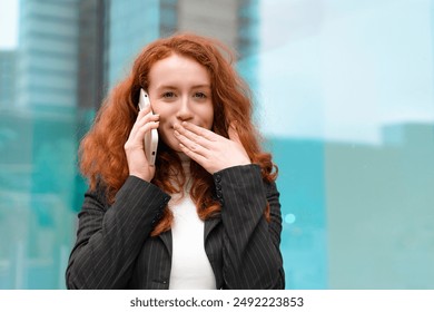 Woman With Red Hair Talking on Phone Outside Modern Building - Powered by Shutterstock