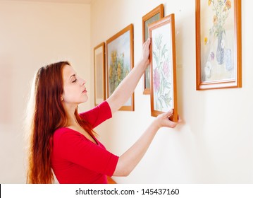  Woman In Red Hanging The Art Pictures On Wall At Home