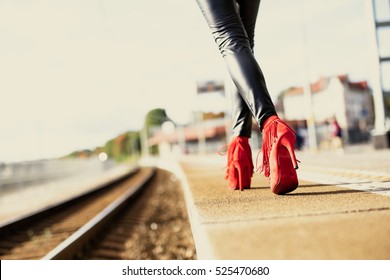 Woman In Red High Heels Walking In Train Station