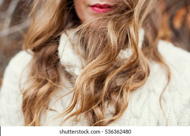 woman with red lips and curly hair