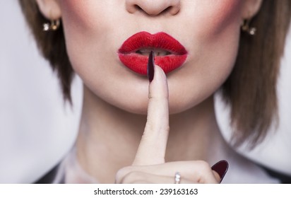 Woman Red Lips With Finger Shh