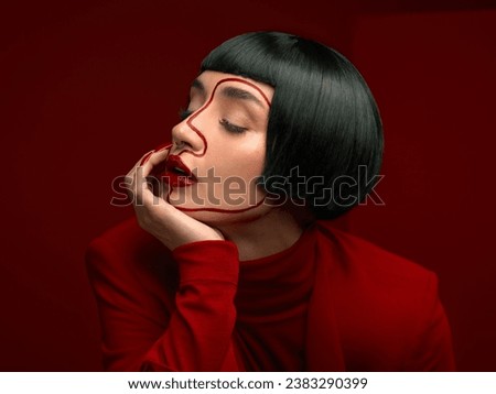 Woman, red makeup and art profile with lines, thinking and ideas with couture, vision and studio background. Girl, model and high fashion with suit, mindset and paint on face for cosmetic beauty