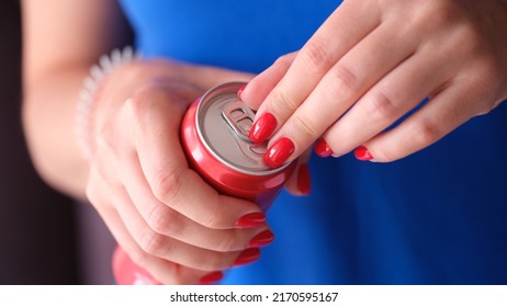 Woman With Red Manicure Opening Iron Can With Drink Closeup