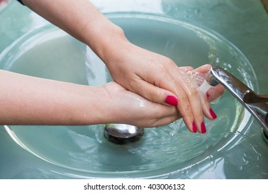 Woman with red nail Cleaning Hands, Washing hands on blue sink background