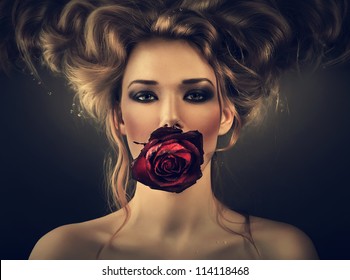 Woman With Red Rose And Drops In Hair In Dark