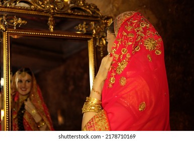 Woman In A Red Sari, Traditional Indian Wedding Dress, The Bride Looks In The Mirror