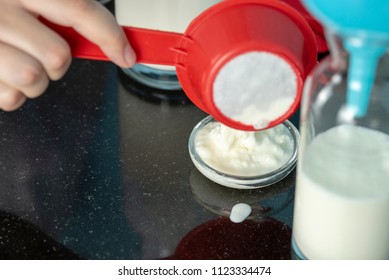 A Woman In The Red Shirt Is Separating Milk Kefir Grains From A Red Strainer In A Small Glass Plate For Next Preparation Of Milk Kefir Closeup