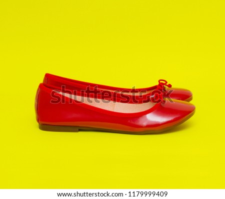 Woman red shoes isolated on the yellow background