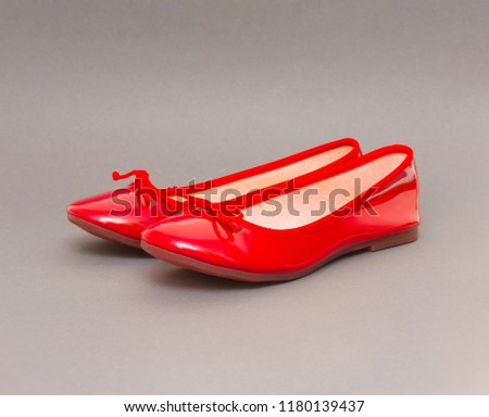 Woman red shoes isolated on the grey background