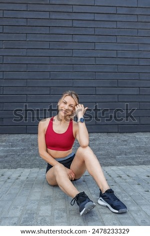 Similar – Woman in sports wear with earphones looking smartphone