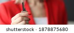 Woman in red suit holding steel key in office close-up. Working in real estate agency concept