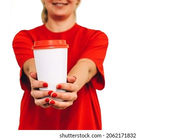 A woman in a red T-shirt holds a white paper cup with coffee in her hands, her nails painted with colorful varnish. Isolate on a white background with space for text. Zero waste concept.  - Powered by Shutterstock