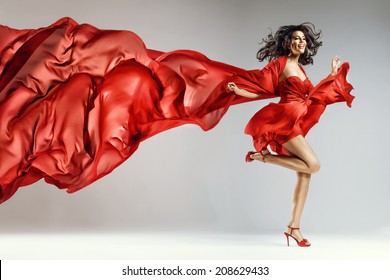 Woman In Red Waving Dress With Flying Fabric