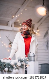 Woman  In Red And White Sit  In Decorated Illuminated Twinkle Lights Glowing Xmas Tree Near House And  Feel Happy