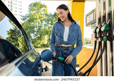 Woman refilling auto with bio fuel at modern petrol station. Eco friendly and convenient car care, automobile fueling offer concept - Powered by Shutterstock