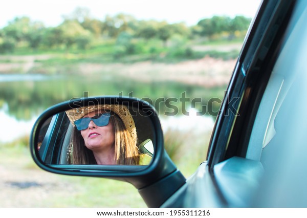 Woman Reflection In\
Back Mirror Of Car.\
Reflection In The Rear View Mirror Of A\
Beautiful Woman\'s Car.