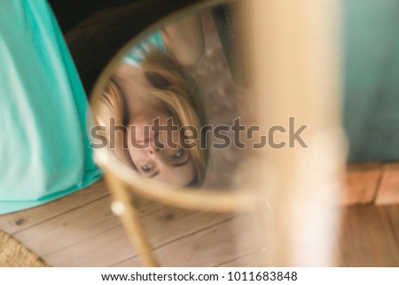 Woman reflection in glass table at home