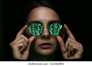 Woman With Reflection Of Matrix Code In Her Tinted Glasses On Dark Background