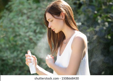 Woman Refreshing With Thermal Water Against Summer Heatwave. Woman Spraying Body Or Hair Mist, Summertime Skincare And Haircare Concept.