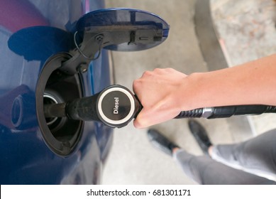 Woman Refueling The Car With Diesel Oil At Petrol Station