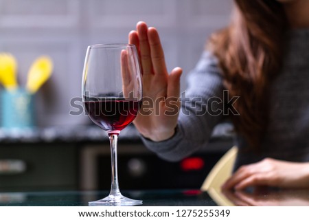 Woman refuses to drink a alcohol. Female alcoholism concept. Treatment of alcohol addiction. Quit booze and alcoholism.
