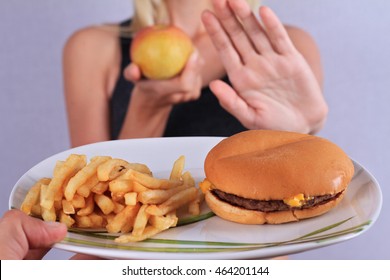 Woman Refuses To Eat Junk Food And Choose Fruits. Healthy Eating And Active Lifestyle Concept