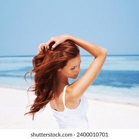 Woman, relax and beach with vacation, hair care and holiday by sea with freedom. Female person, beauty and outdoor with calm and ginger hairstyle in the sun in summer with travel and ocean on trip - Powered by Shutterstock