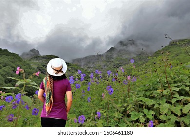 Woman Relax And Hppy Hours On Hill,fog On Mountain In India,beautiful Blue Flower(blue Popy) With Fog On Valley Of Flowers National Park,India