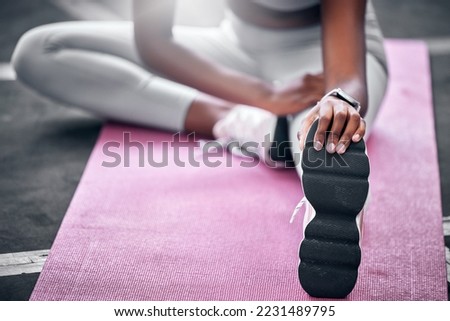 Woman, relax and stretching legs for workout exercise on gym or yoga studio floor. Personal trainer, fitness and wellness flexibility or healthy body, release tension or muscle cardio sports warm up