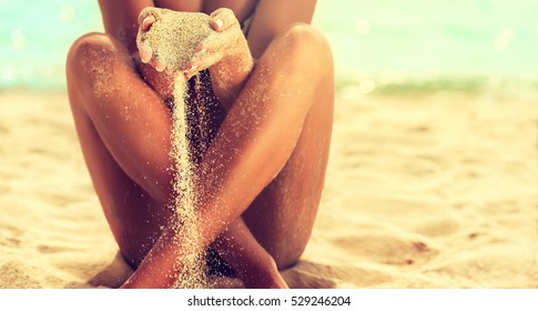 Woman In Relaxation On Tropical Beach with sand , body parts 