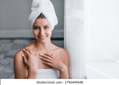 Woman relaxes after bath procedures in his room. Morning skin care routine. Stay at home while quarantined to avoid coronavirus.