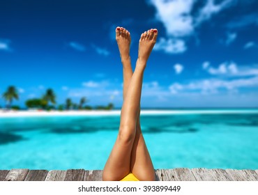 Woman Relaxing At Beach Jetty