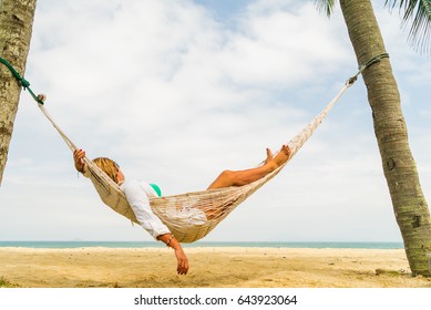 Woman Relaxing At The Beach On A Hammock