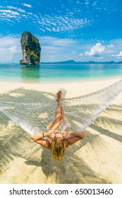 Woman Relaxing At The Beach On A Hammock