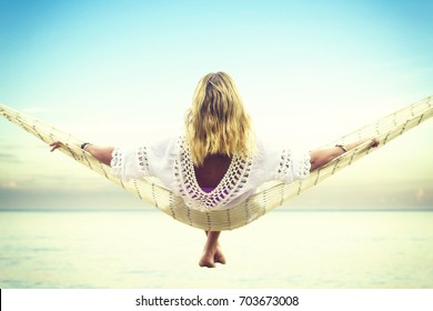 Woman Relaxing At The Beach On A Hammock