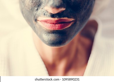 Woman Relaxing With A Charcoal Facial Mask