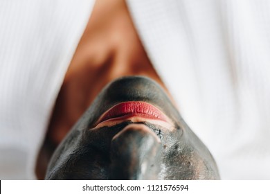 Woman Relaxing With A Charcoal Facial Mask
