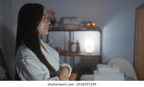 Woman relaxing in a dimly lit spa with candles, towels, and wellness items in the background - Powered by Shutterstock