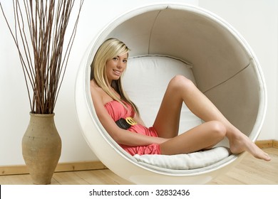 Woman Relaxing In An Egg Chair