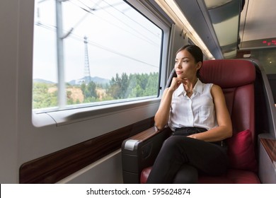 Woman Relaxing Enjoying View During Morning Commute. Business Class Seat In Train. Asian Businesswoman Pensive Looking Out The Window In Travel Transport.