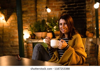 Woman Relaxing In Her Backyard. Night Scene.