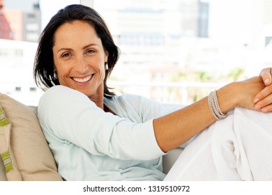 Woman relaxing at home - beautiful middle aged brunette - portrait