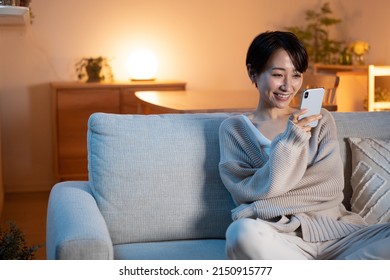Woman Relaxing At Home At Night